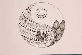 this is the image of a yin yang, one side mandala and the other tangled.