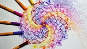 this is the image of a twisted colored mandala with stippling shading on the side