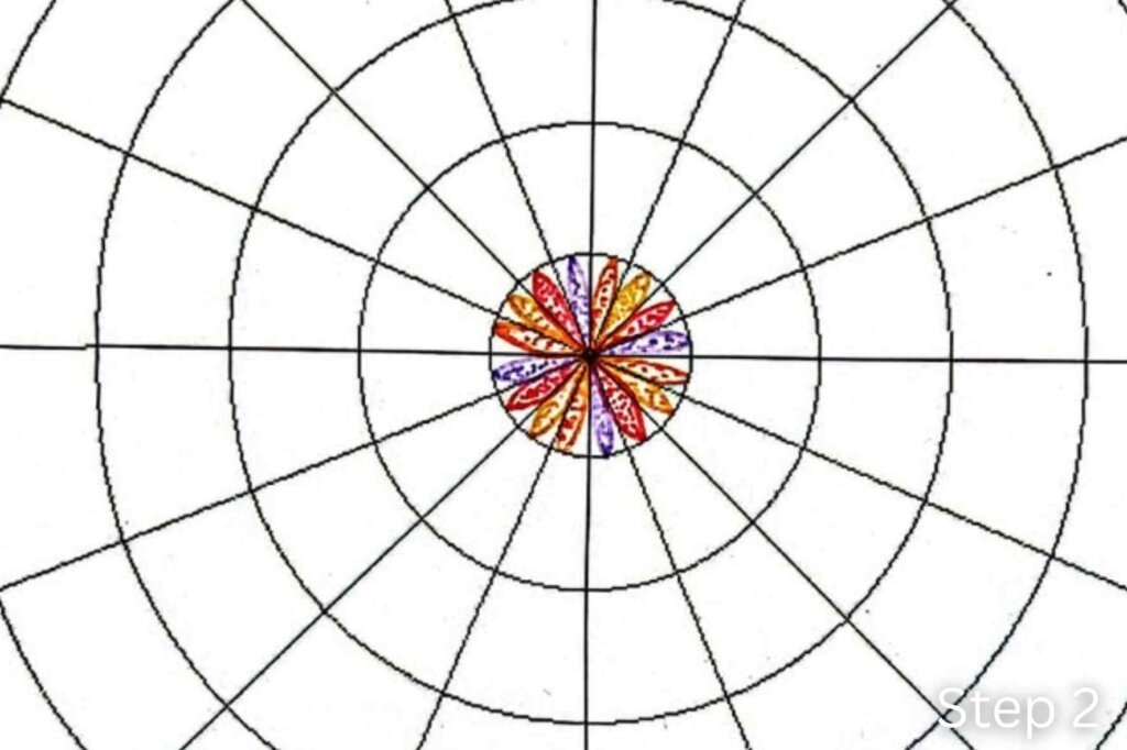 Step 2 of a twisted mandala tutorial showing the center petals enhanced with stippling to add texture and depth.