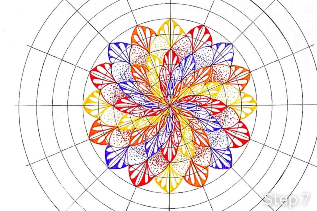 Step 7 of a twisted mandala tutorial showing another ring of pointed petals decorated with reversed teardrops and dots.