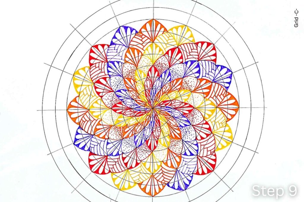 Step 9 of a twisted mandala tutorial showing a new ring of petals decorated with one large reversed teardrop and two smaller reversed teardrops.