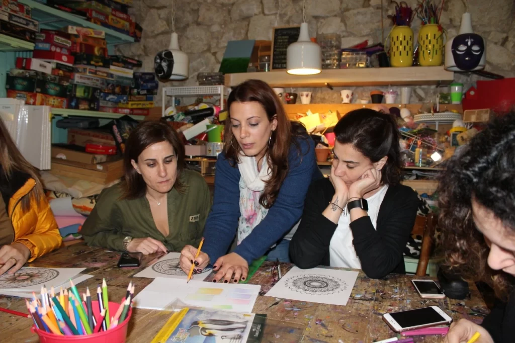 three woman coloring mandalas